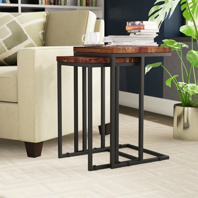 nesting tables set with wood tops and metal frames, next to a sofa