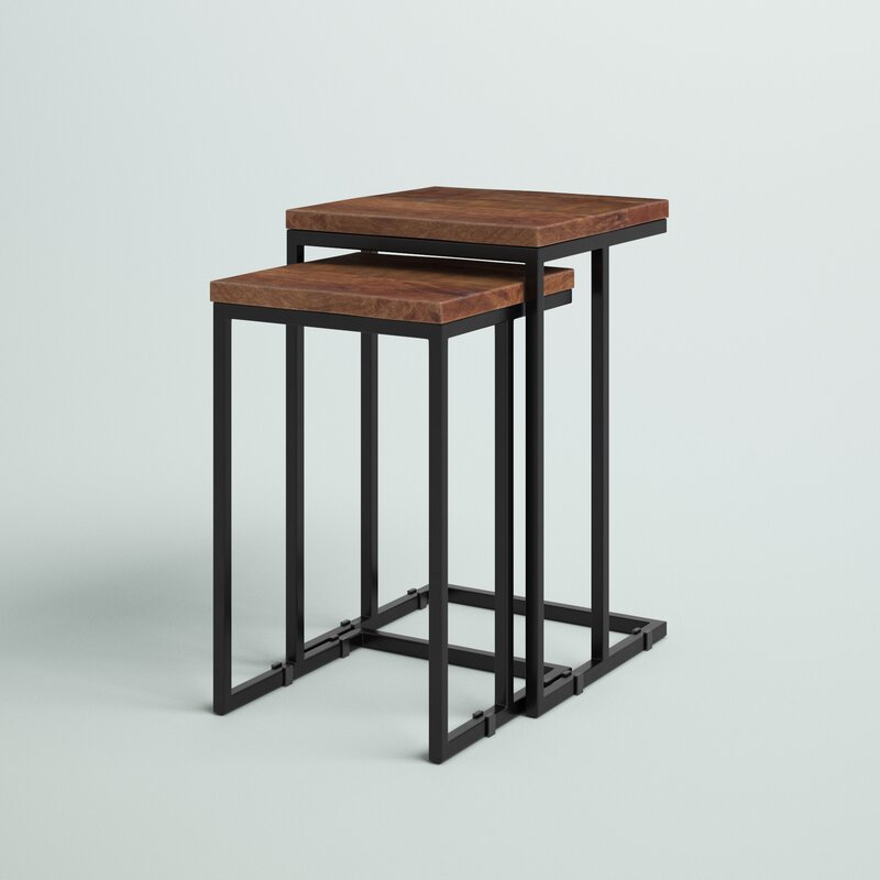 Nesting tables set with wood tops and metal frames, next to a sofa