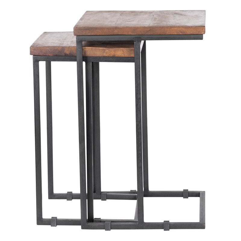 Nesting tables set with wood tops and metal frames, next to a sofa